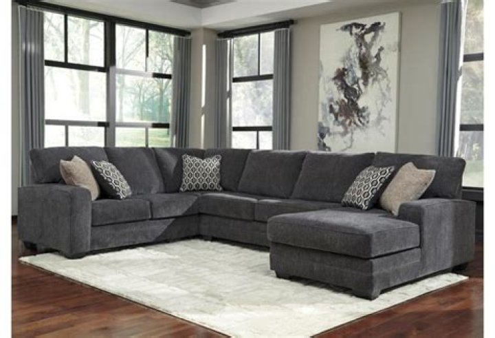 How do you place a rug on a sectional couch